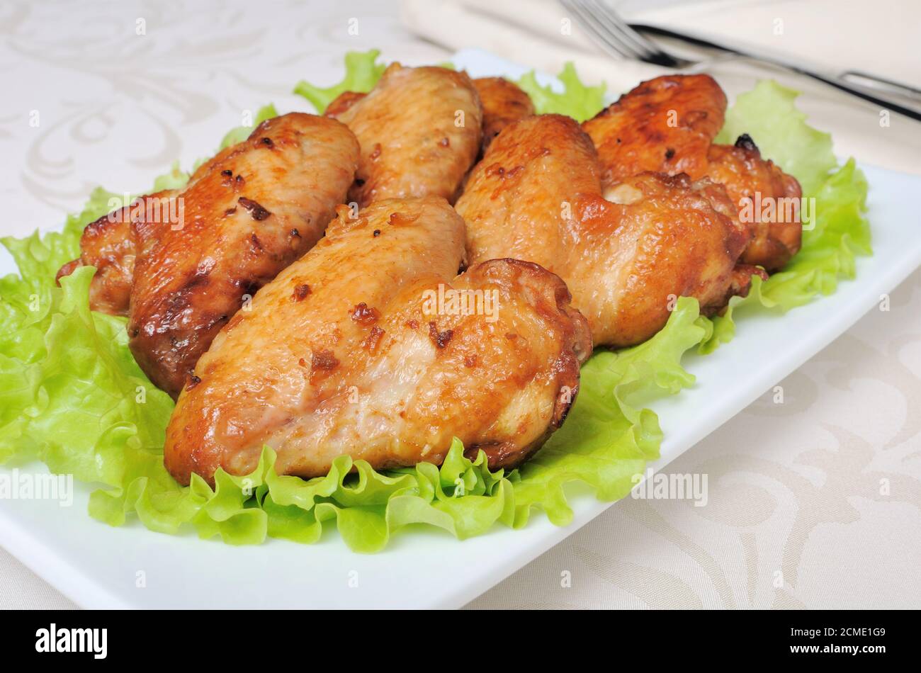 Baked chicken wings with garlic Stock Photo - Alamy