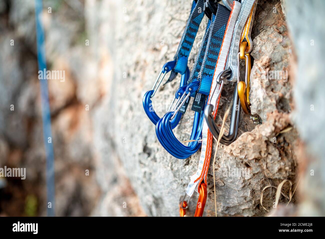 Closeup shot of a variety of carabiner hooks, rope, and other