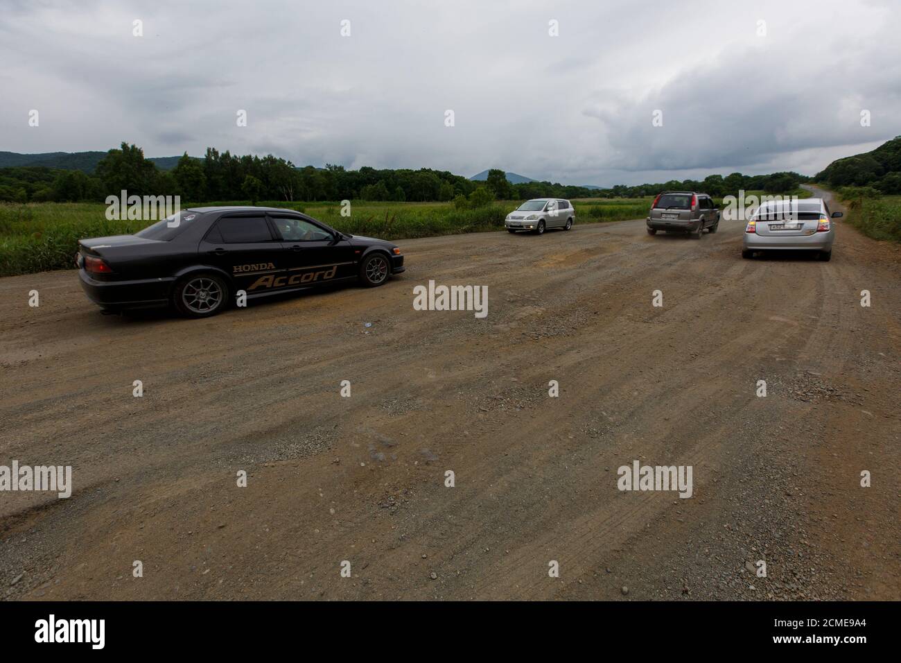 The car drives on a bad asphalt road. Killed Russian roads Stock Photo