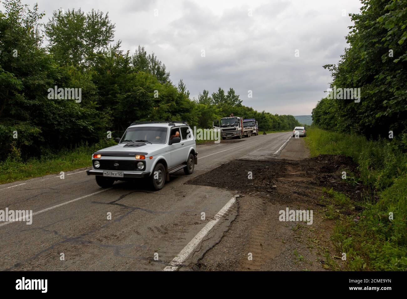 The car drives on a bad asphalt road. Killed Russian roads Stock Photo