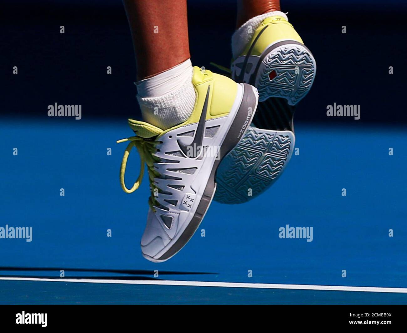 The shoes of Maria Sharapova of Russia are seen as she serves to Kirsten  Flipkens of Belgium during their women's singles match at the Australian  Open tennis tournament in Melbourne, January 20,