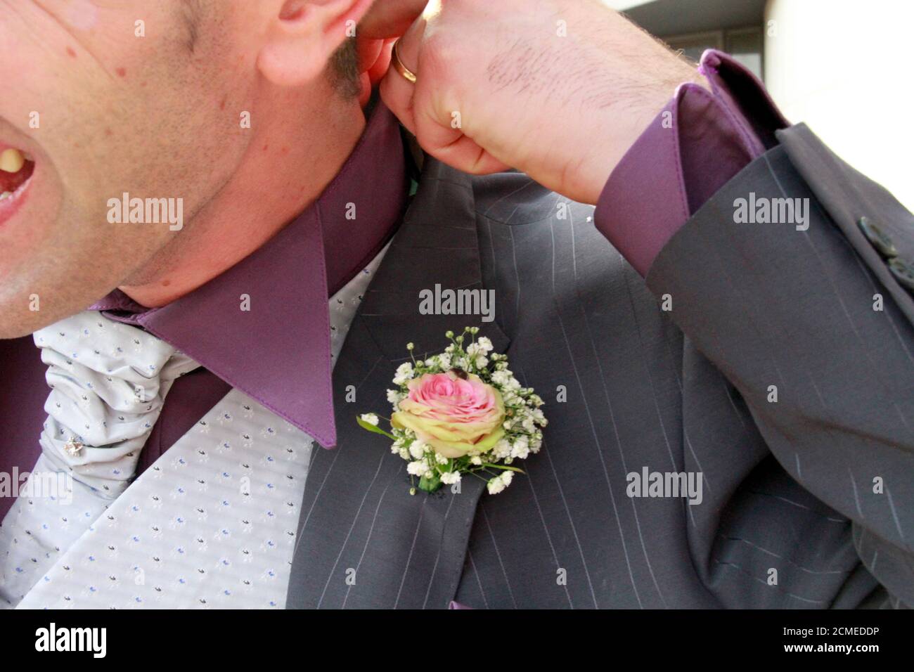 rose flower in the boutonniere of the groom's suit for wedding. High quality photo Stock Photo
