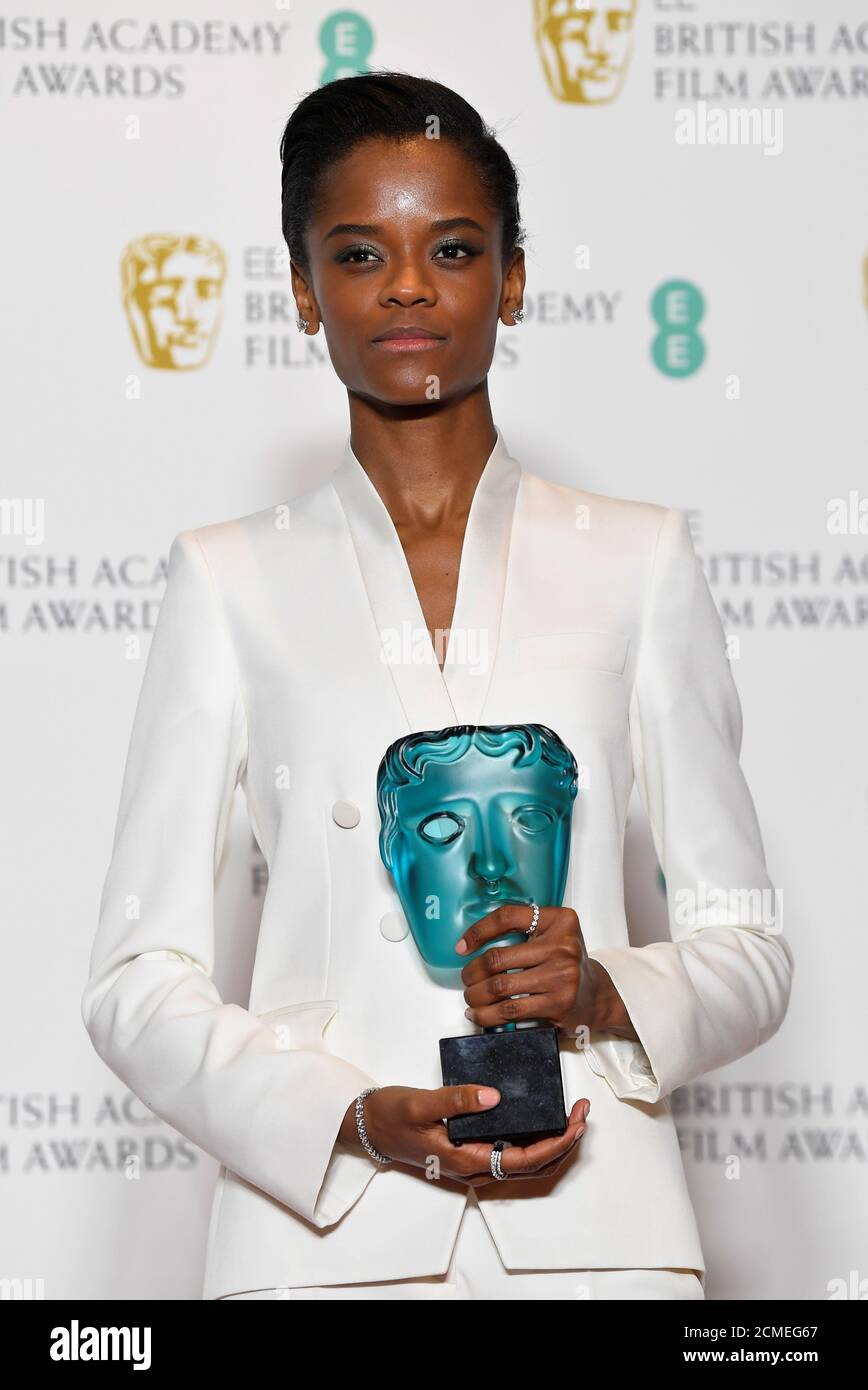 Letitia Wright holds her award for EE Rising Star at the British