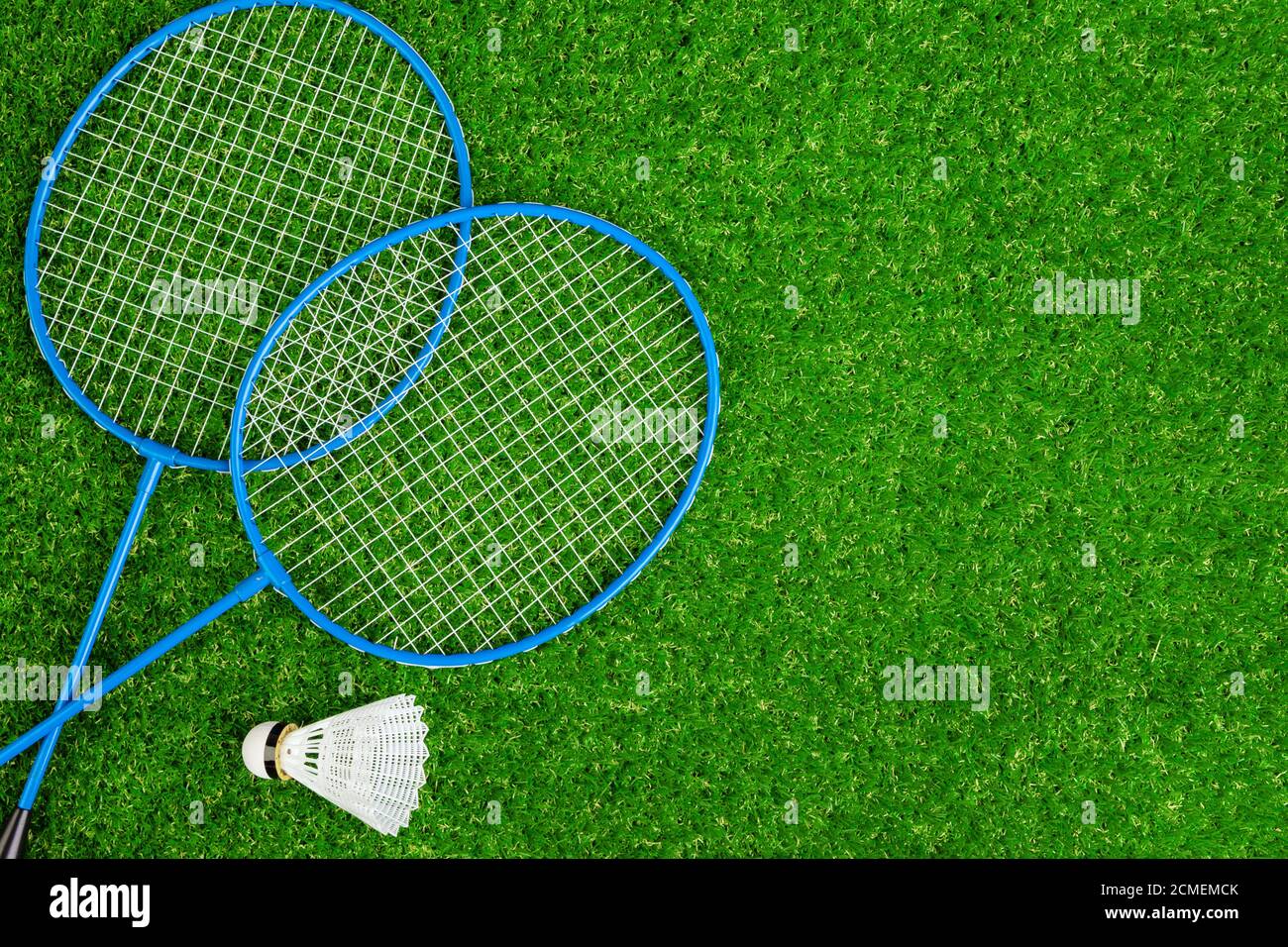 Badminton game rackets and shuttlecock on grass Stock Photo Alamy