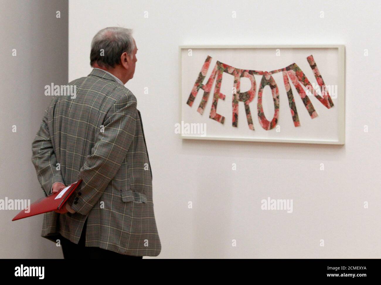 A man looks at the work 'Heroin' by Jack Pierson from the Judith Rothschild Foundation Contemporary Drawings Collection of the Museum of Modern Art New York (MoMA)  that is on show in the Martin-Gropius museum in Berlin, March 10, 2011. The exhibition 'Kompass-Zeichnungen' opens to the public on March 11.  REUTERS/Thomas Peter  (GERMANY - Tags: ENTERTAINMENT) Stock Photo