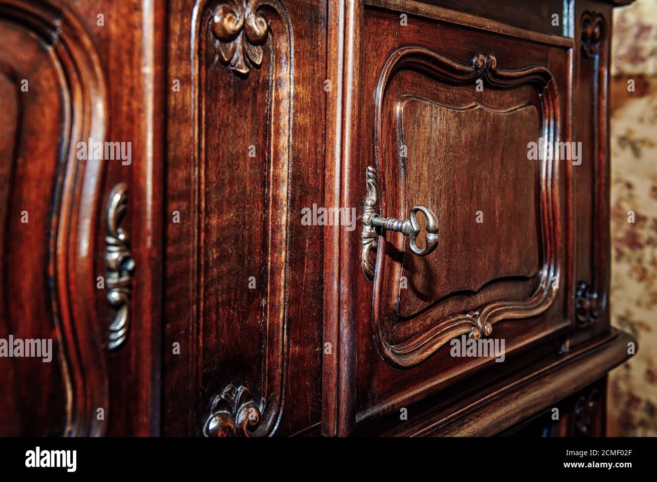 Key and door to an old wooden cabinet Stock Photo