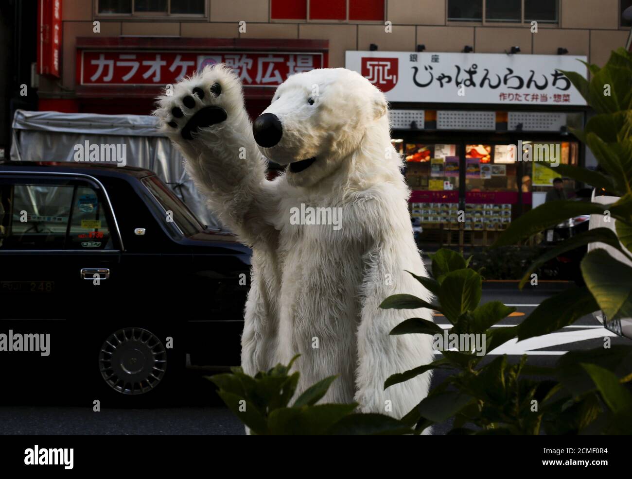 A man in a polar bear costumes walks through central Tokyo during a rally organised by environment protection groups ahead of the 2015 Paris Climate Conference, known as the COP21 summit, November 28, 2015.  REUTERS/Thomas Peter Stock Photo