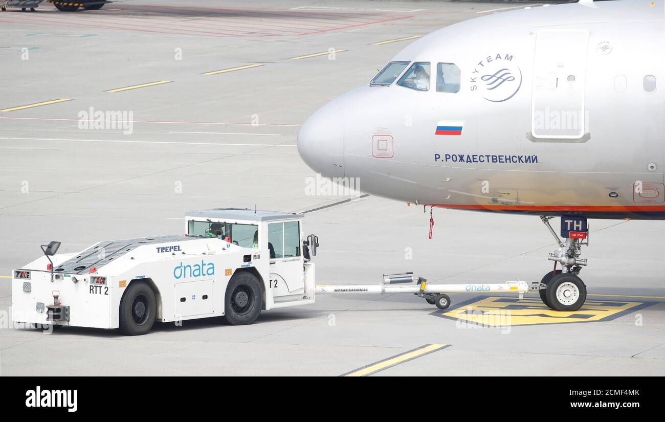 An Airbus A321-211 aircraft of Russian Aeroflot airlines is pulled by a  Trepel pushback tractor