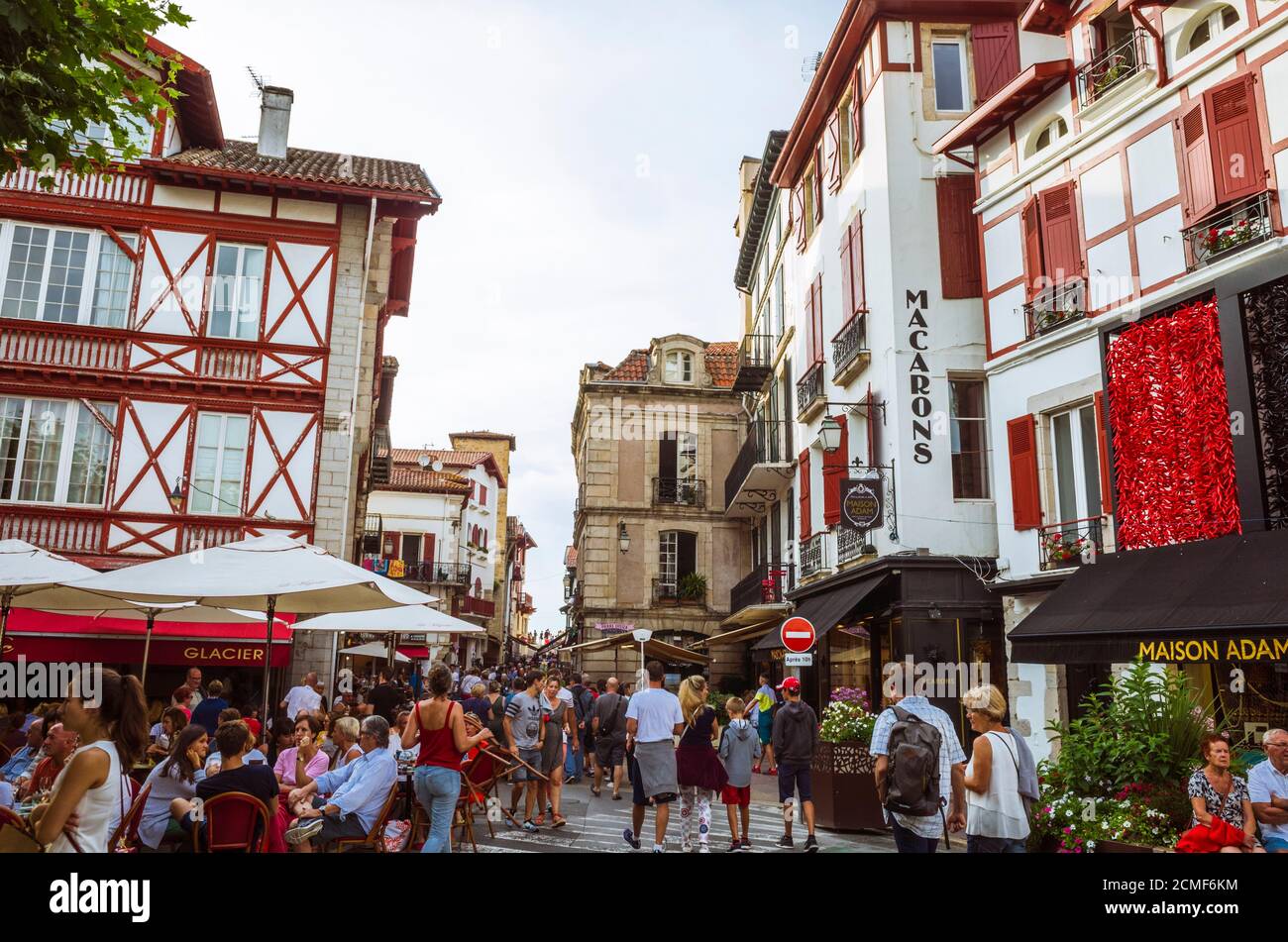 Saint Jean de Luz, French Basque Country, France - July 13th, 2019 : People walk in the Place Louis XIV square in the historic center of Saint Jean de Stock Photo