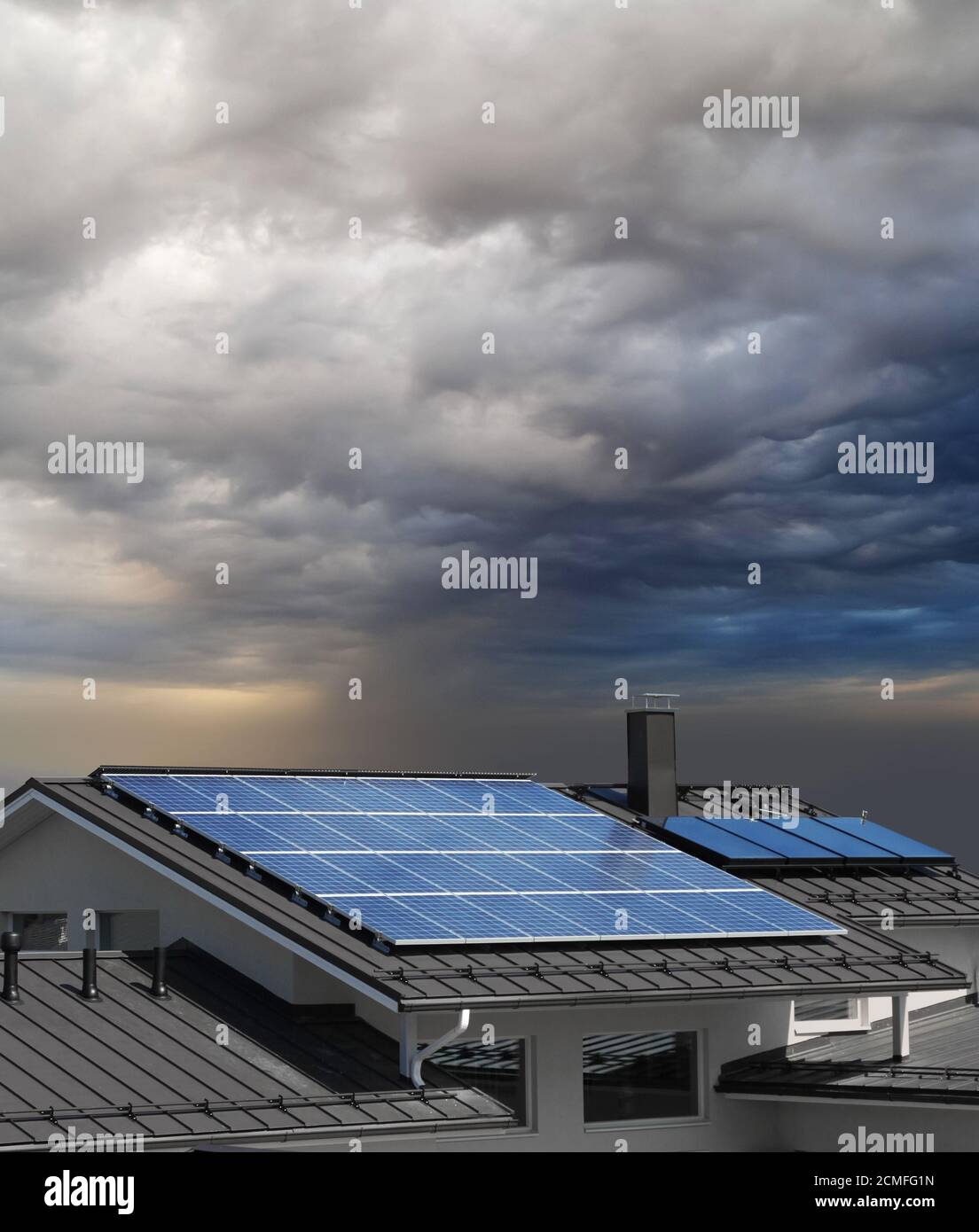 Solar panel system on house roof, stormy rain clouds approaching Stock ...