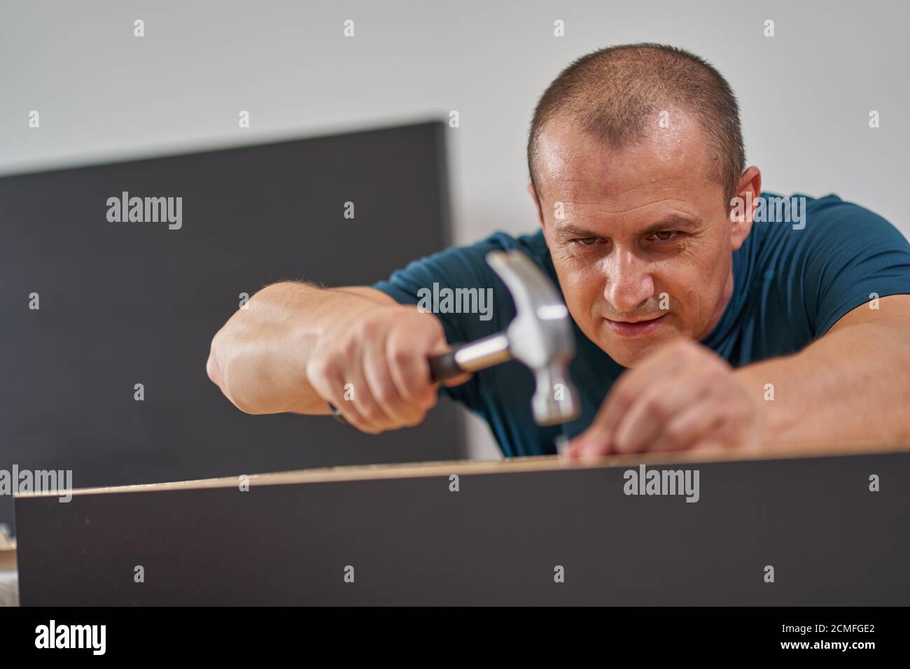 Man assembling his new furniture when moving house Stock Photo Alamy