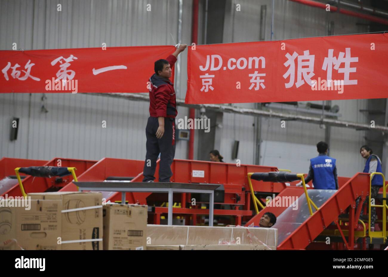 An employee works at a JD.com logistics centre in Langfang, Hebei province, November 10, 2015. REUTERS/Jason Lee/File Photo Stock Photo