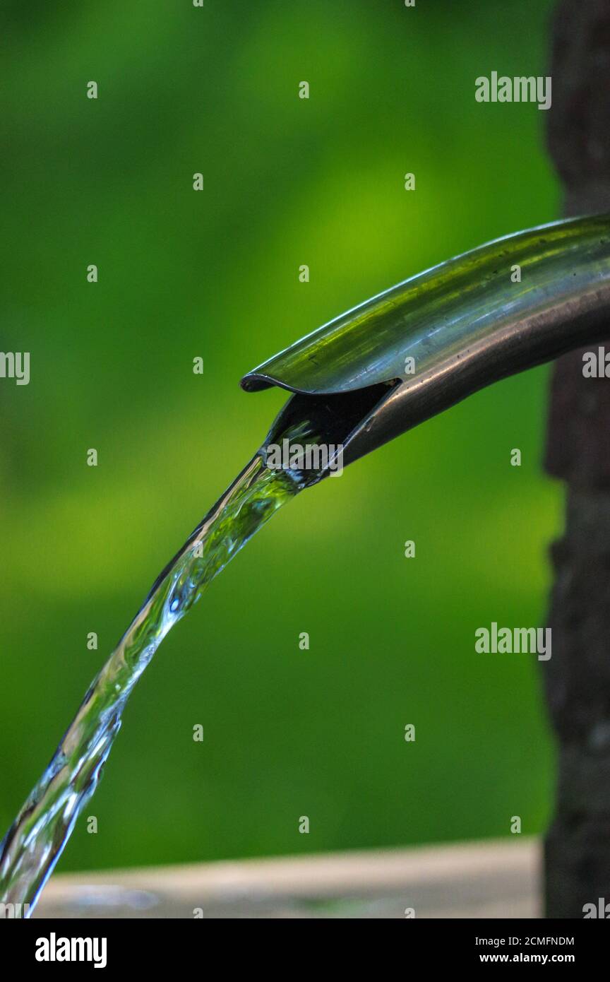 Close up of running water from a metal tap Stock Photo