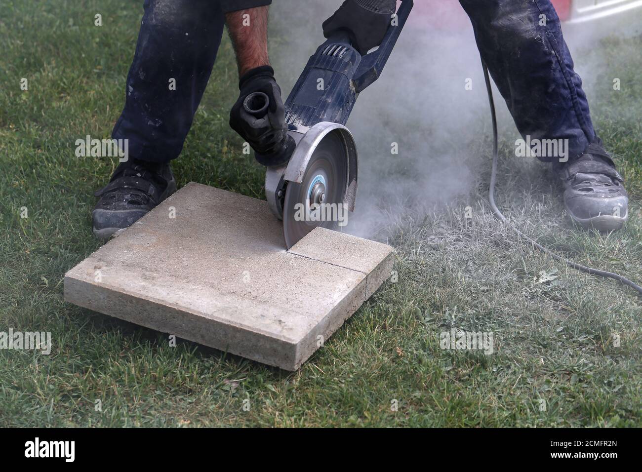 Industrial construction worker using a professional angle grinder Stock Photo