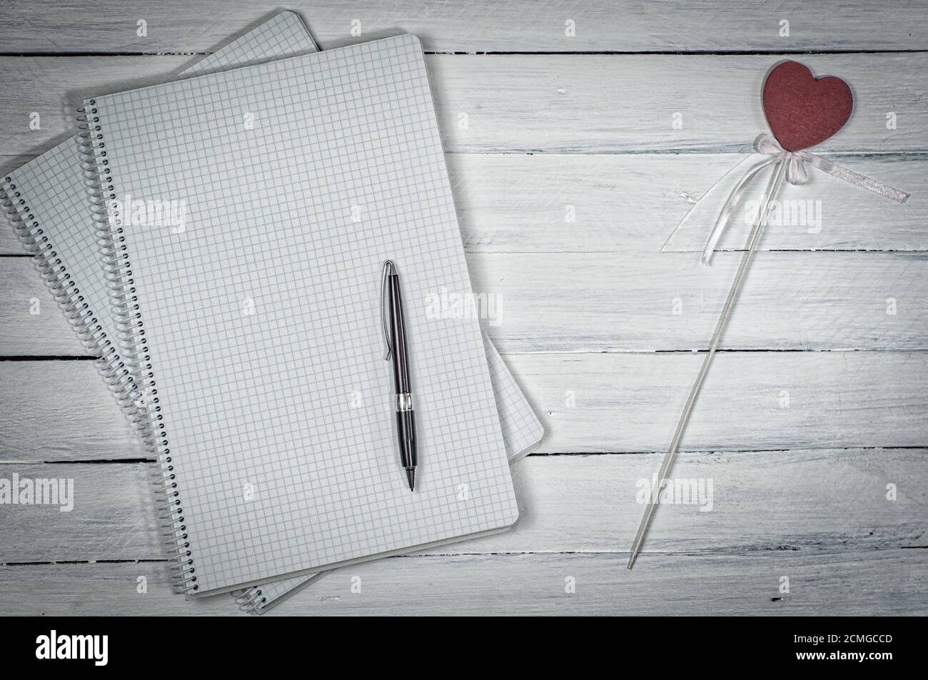 Open notebook in the small cell with a pen Stock Photo