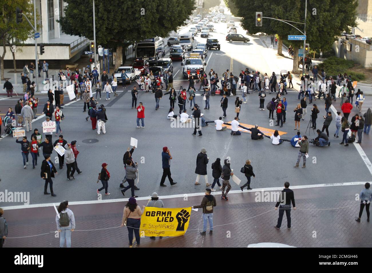 People block an intersection as they gather outside a Federal Building while protesting against Immigration and Customs Enforcement (ICE) raids on Central American refugees in Los Angeles, California January 26, 2016.   REUTERS/Mario Anzuoni Stock Photo