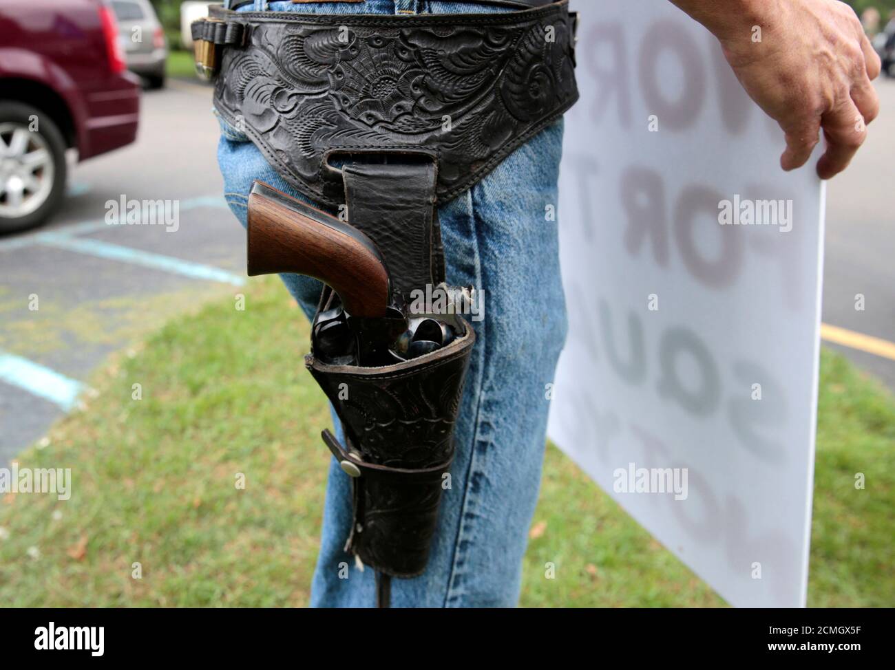 A gun rights advocate wears a 44 Magnum single action pistol outside a 'End The Gun Violence' Town Hall in Commerce Township, Michigan, U.S. October 1, 2019.    REUTERS/Rebecca Cook Stock Photo