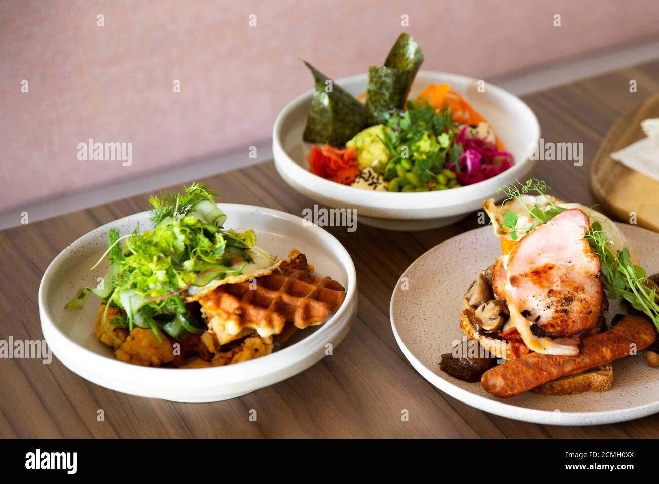 All day big breakfast poke bowl & waffles on cafe table setting under
