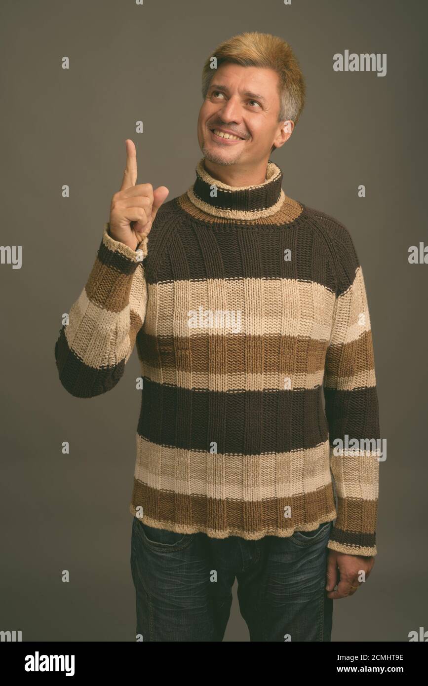 Portrait Of Happy Man With Blond Hair Wearing Turtleneck Sweater Stock portrait-of-happy-man-with-blond-hair-wearing-turtleneck-sweater-stock