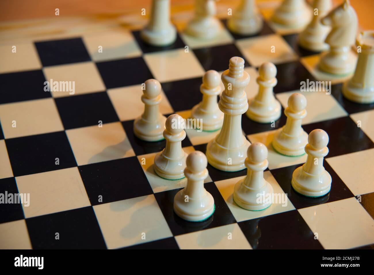 Chess. White king surrounded by white pawns. Stock Photo