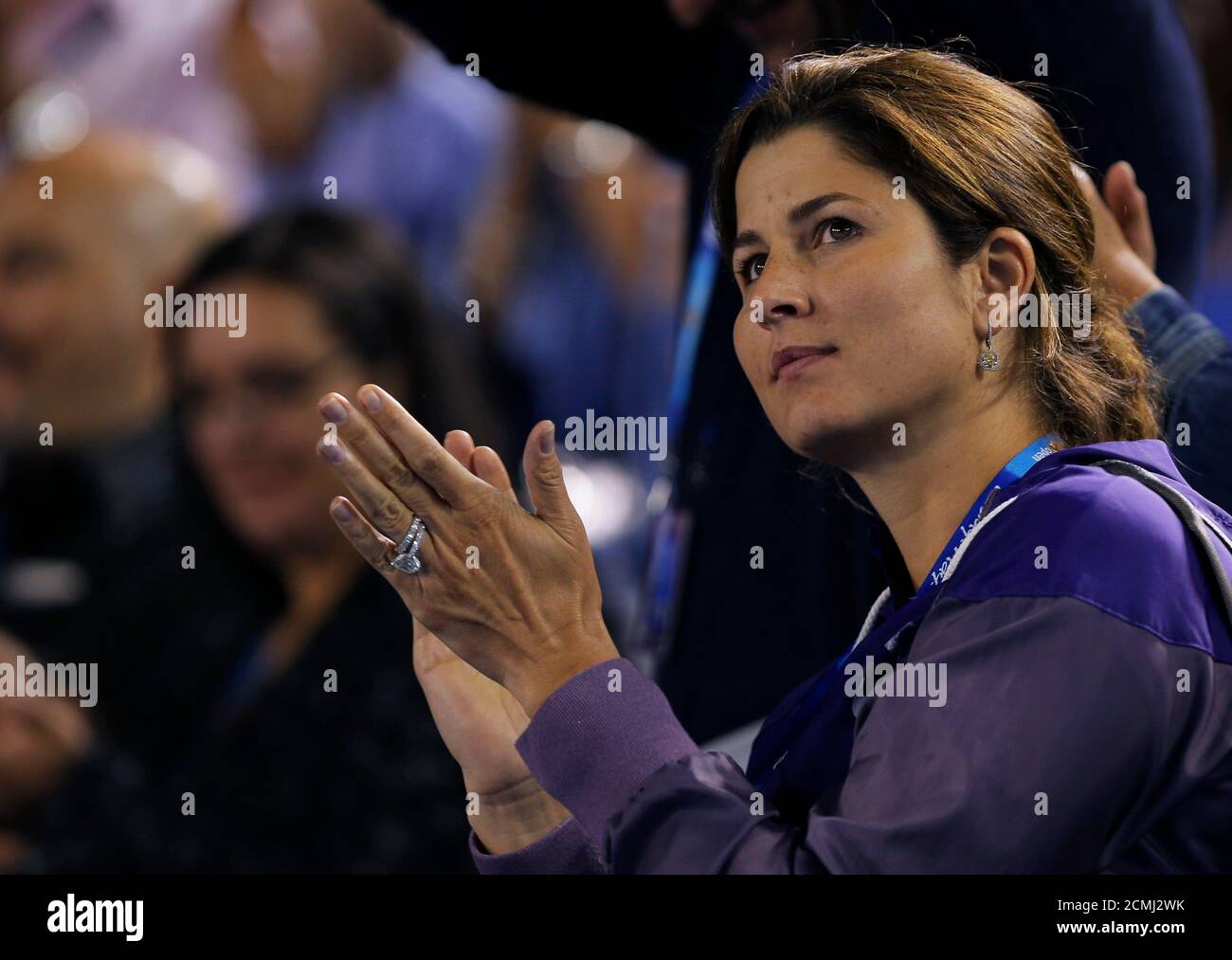 Mirka Federer, wife of Roger Federer of Switzerland, applauds as he gives  an interview after he defeated Jo-Wilfried Tsonga of France in their men's  singles quarter-final match at the Australian Open tennis