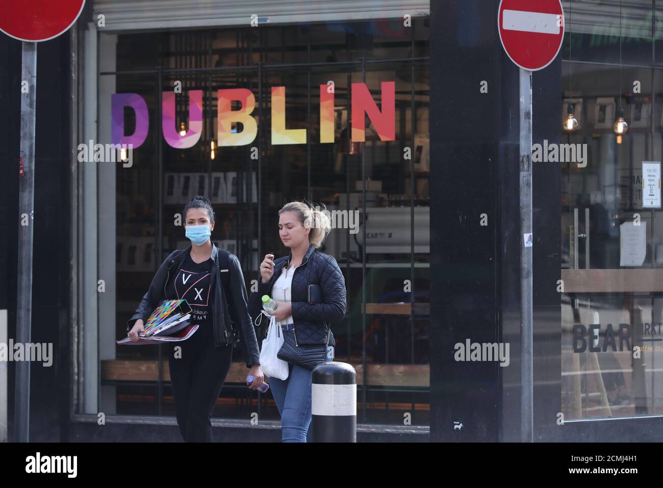A person wearing a mask (left) in Dublin city centre, amid calls for public health authorities to publish further details of Covid-19 outbreaks in businesses and public settings. Stock Photo
