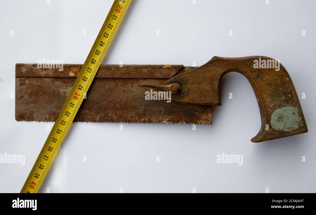 old vintage rusty tenon saw  and tape measure isolated on white background Stock Photo