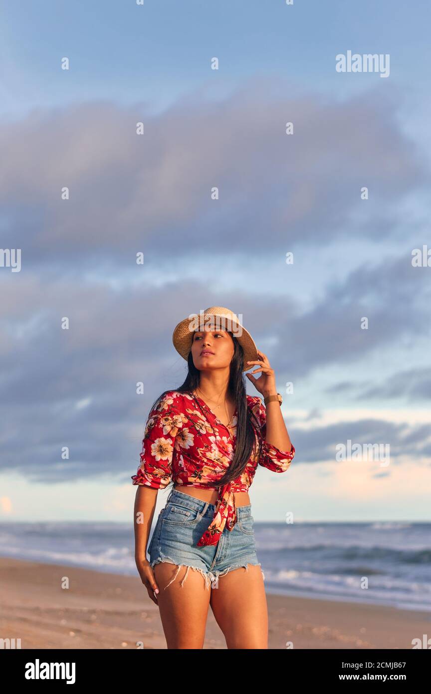 A young gorgeous woman on the beach at sunset Stock Photo