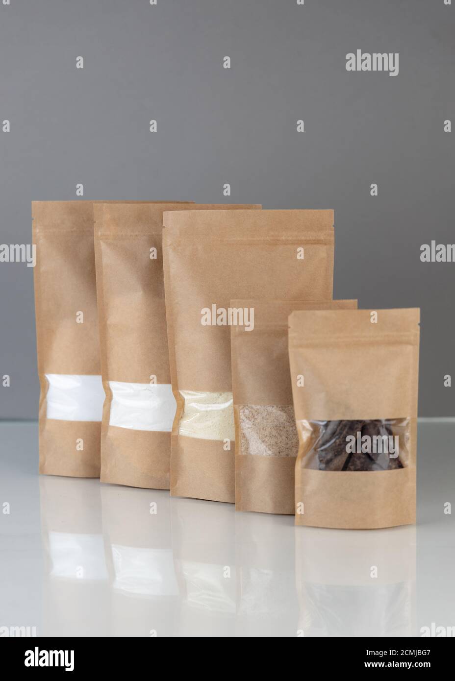 Download Brown Kraft Paper Doypack Bags With Groceries Front View On A Gray Background Packaging For Foods And Goods Template Mock Up Packs With Windows For Stock Photo Alamy