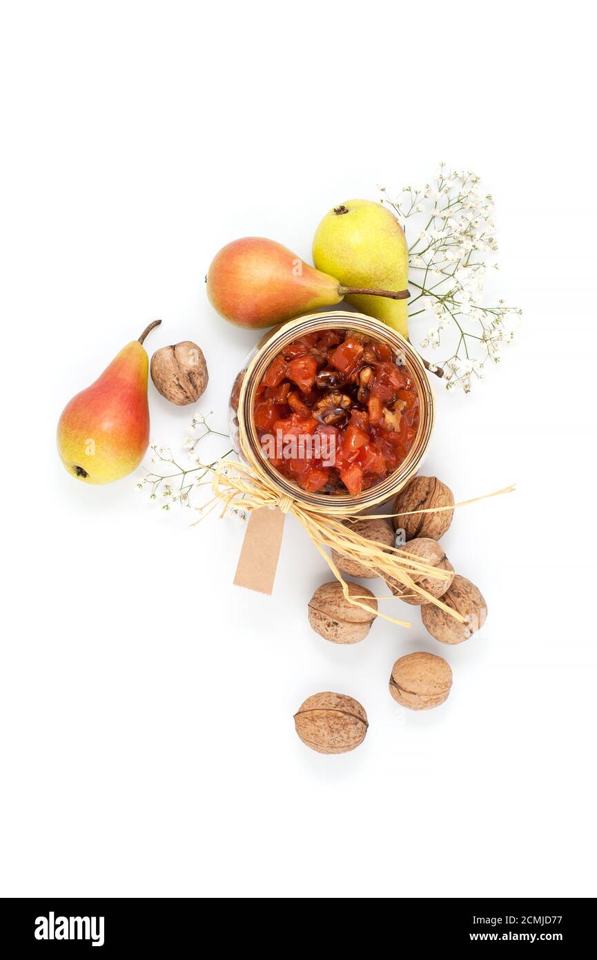 Pear jam, pears and walnuts on a white background top view. Stock Photo
