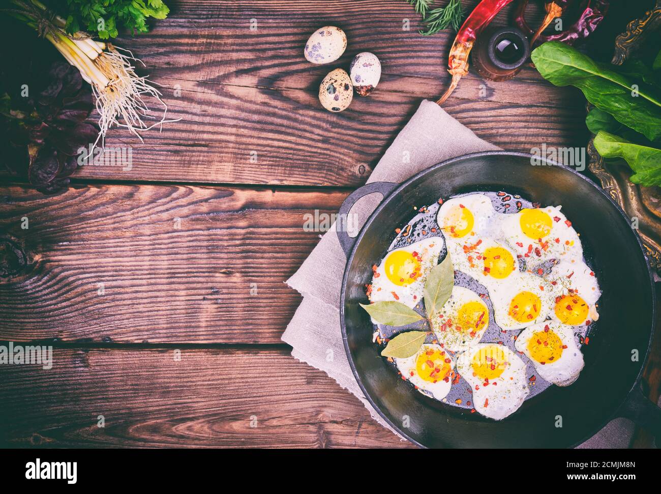 Fried quail eggs in a castiron frying pan Stock Photo Alamy