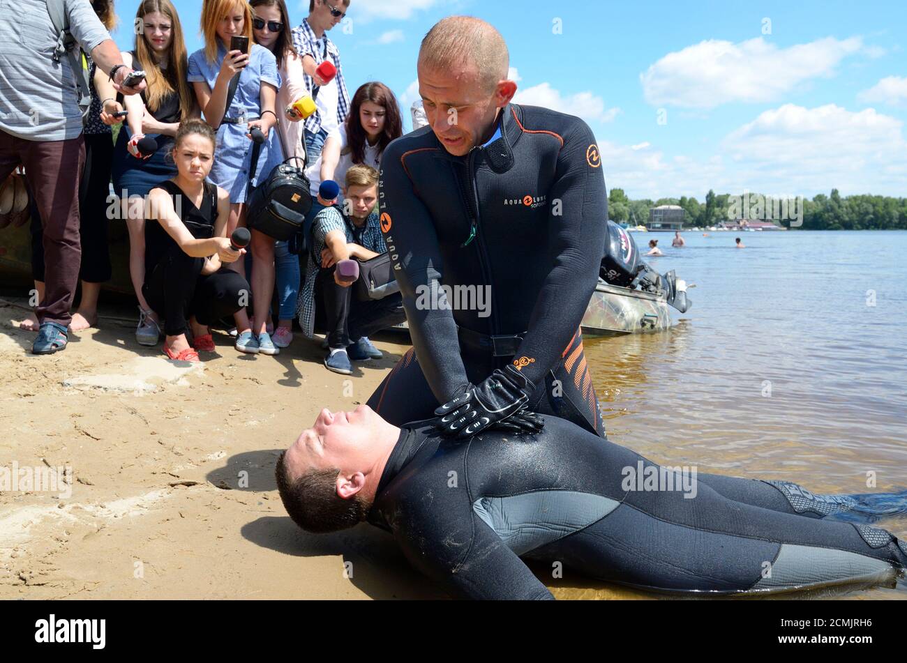 Lesson of artificial respiration. Rescuer pressing on a drowning s chest by hands. June 12, 2018. Kiev, Ukraine Stock Photo