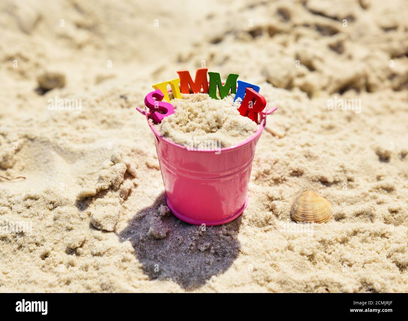 Pink metal baby bucket with sand Stock Photo