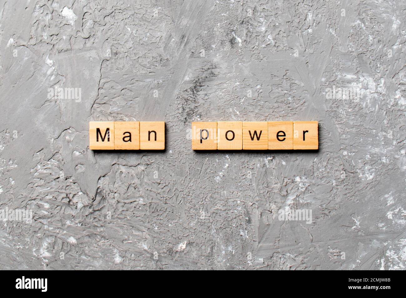 Man Power word written on wood block. Man Power text on cement table ...