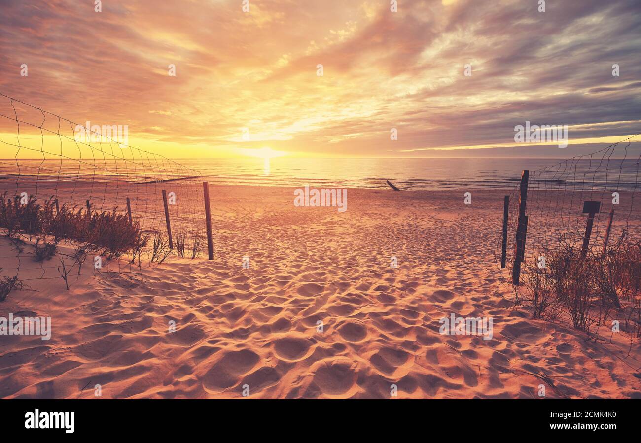 Scenic beach entrance at a beautiful sunset, color toned picture Stock