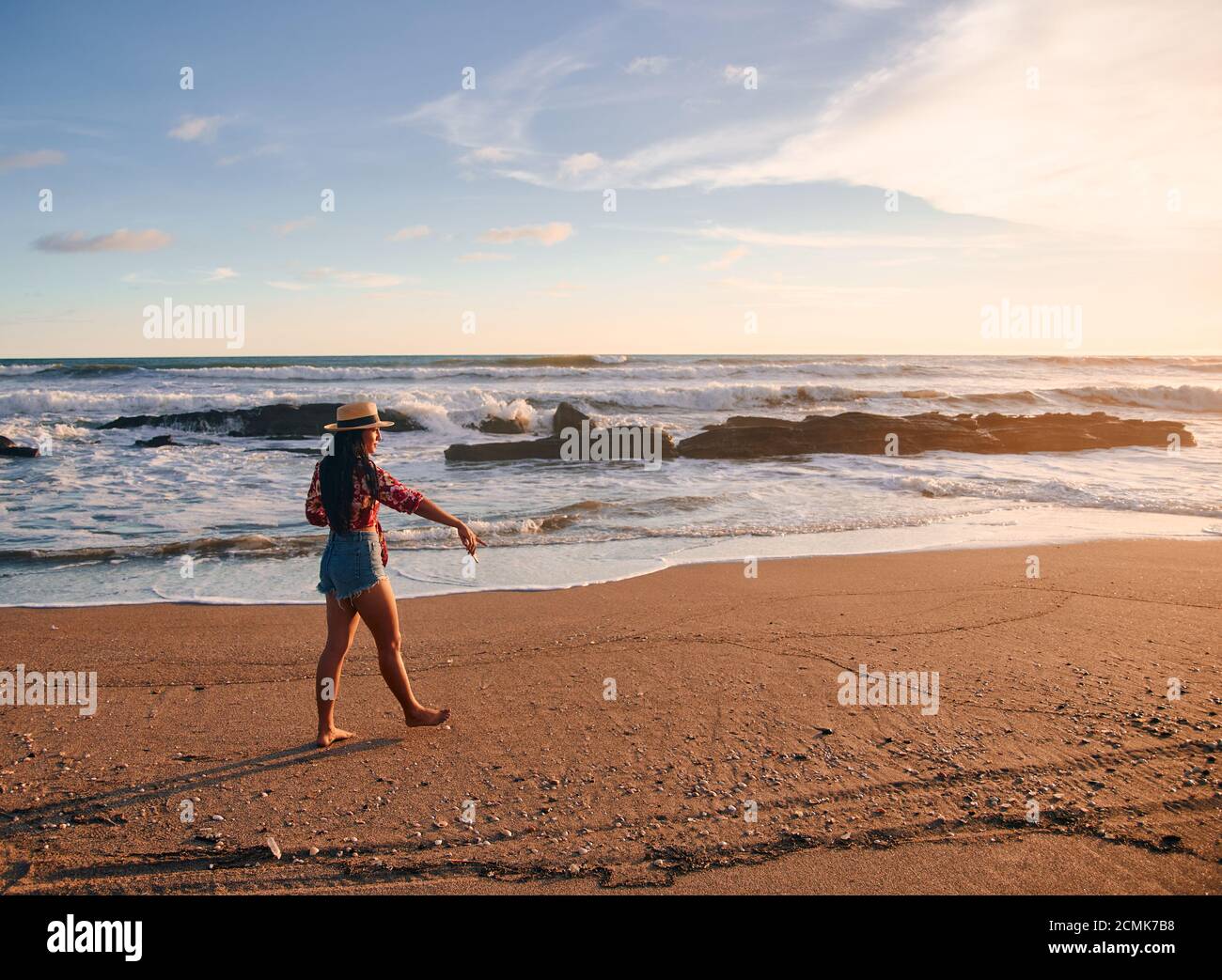 Woman walking tropical beach sunset hi-res stock photography and images ...