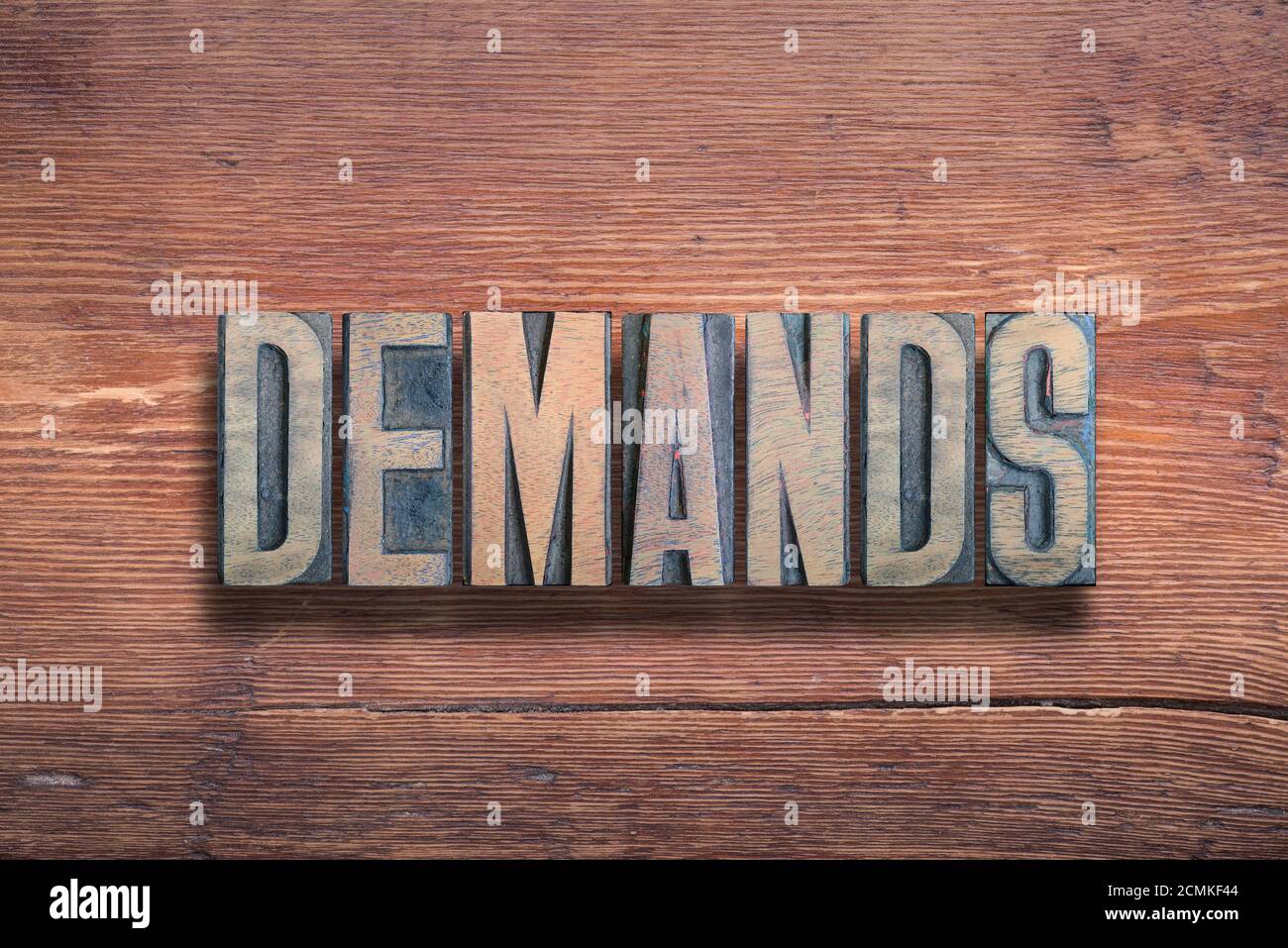 demands word combined on vintage varnished wooden surface Stock Photo