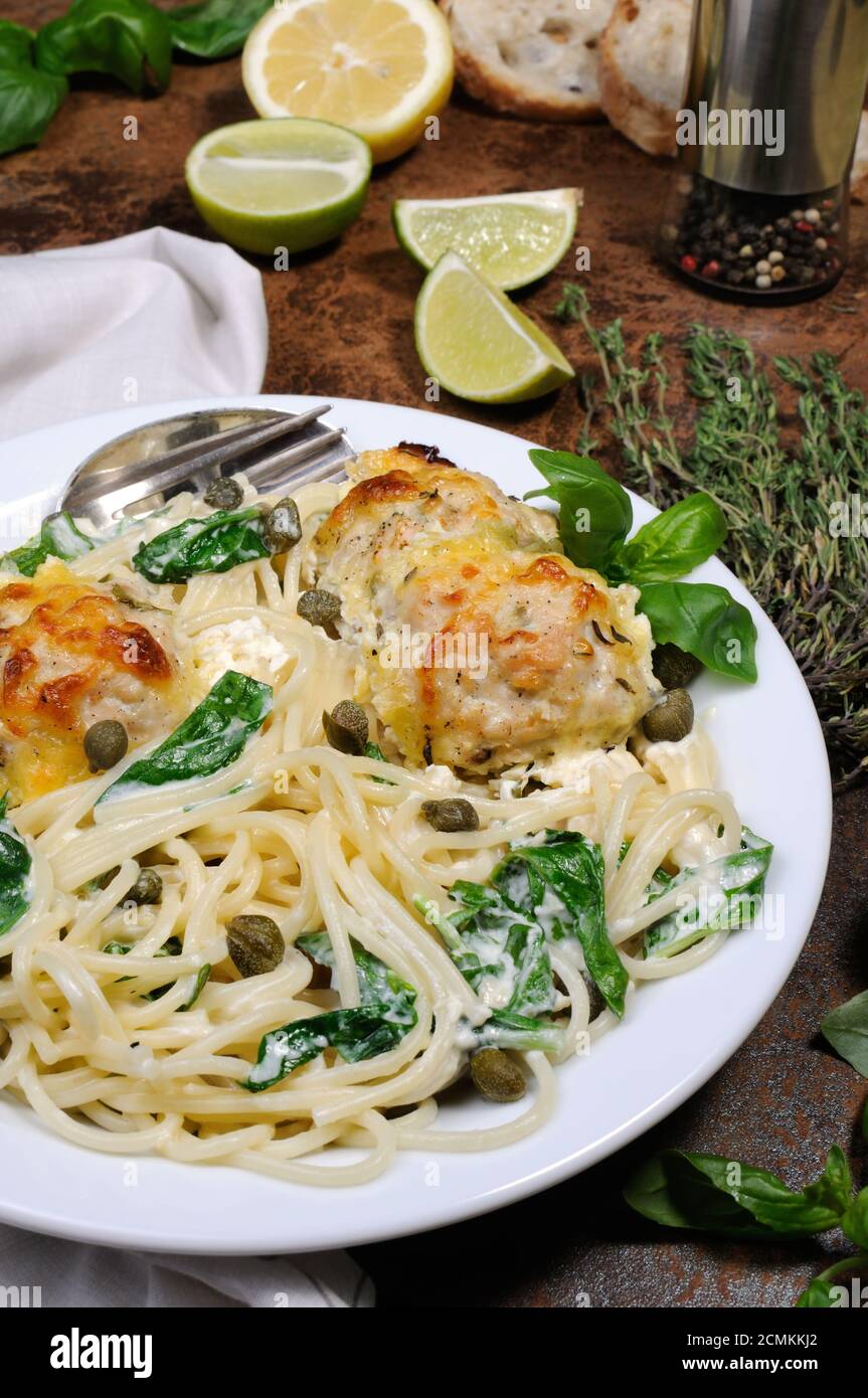 Spaghetti with chicken meatballs in cheese cream sauce , spinach and