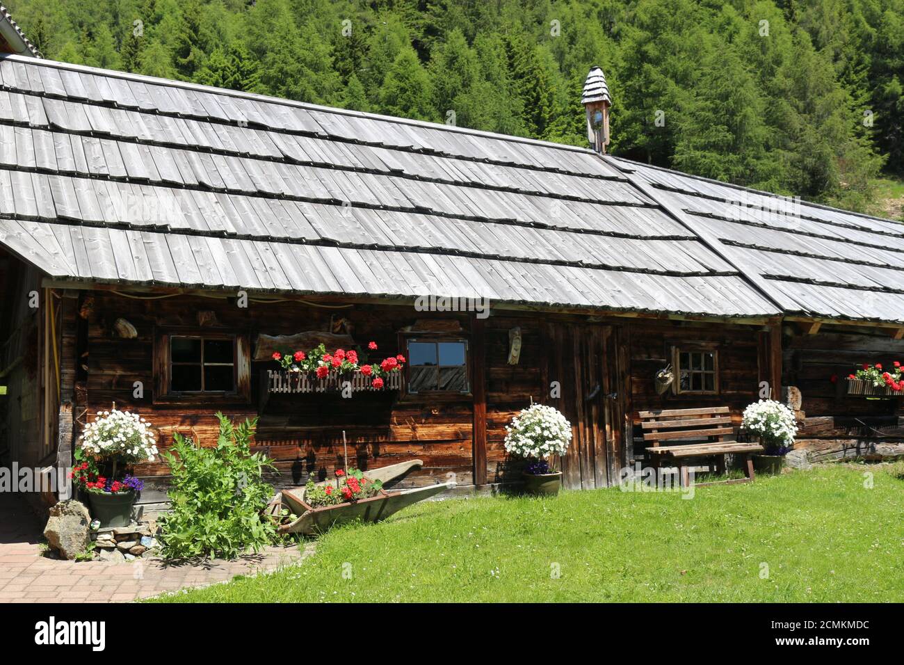 Old wooden barn with shingle roof in the mountains. On Sommeregger Alm, height 1720 m, above the Millstatt lake. Stock Photo