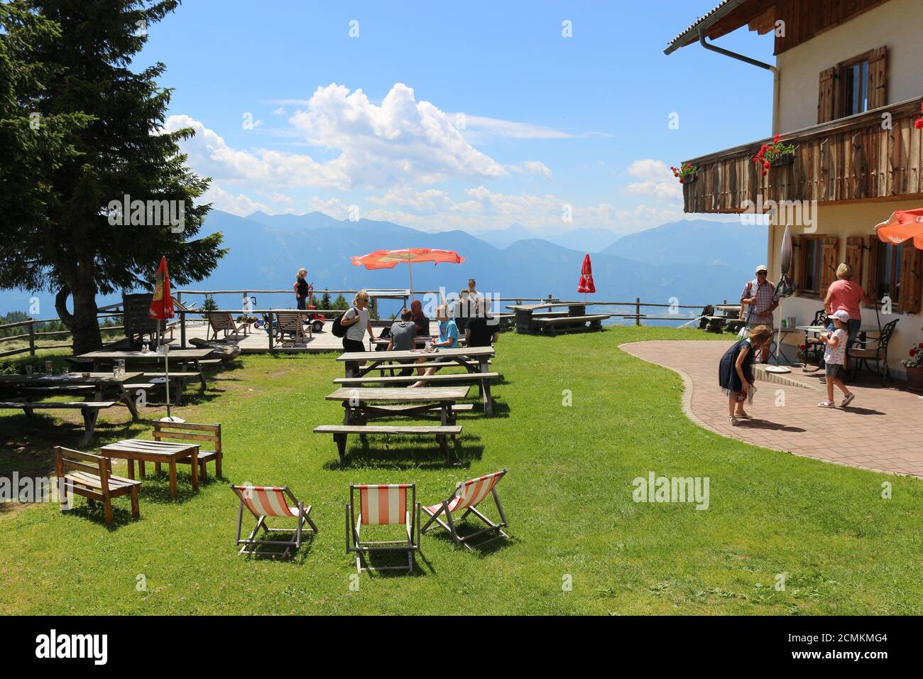 Alpine restaurant on Sommeregger alm, height 1720 m, above the Millstatt lake. Beautiful mountain landscape around. Austria, Europe. Stock Photo