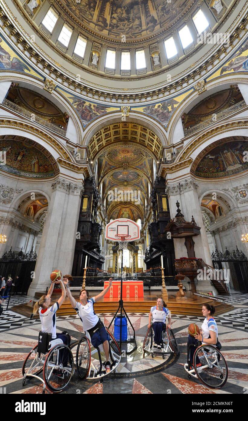 Great Britain wheelchair basketball players, Judith Hamer, Sarah Grady, Helen Turner, Louise Sugden play in the centre of St. Paul's Cathedral during a media event in London August 24, 2012. They were promoting a special service to be attended by Paralympians in advance of the London 2012 Paralympic games which start on August 29. REUTERS/Toby Melville (BRITAIN - Tags: SPORT RELIGION SOCIETY) Stock Photo