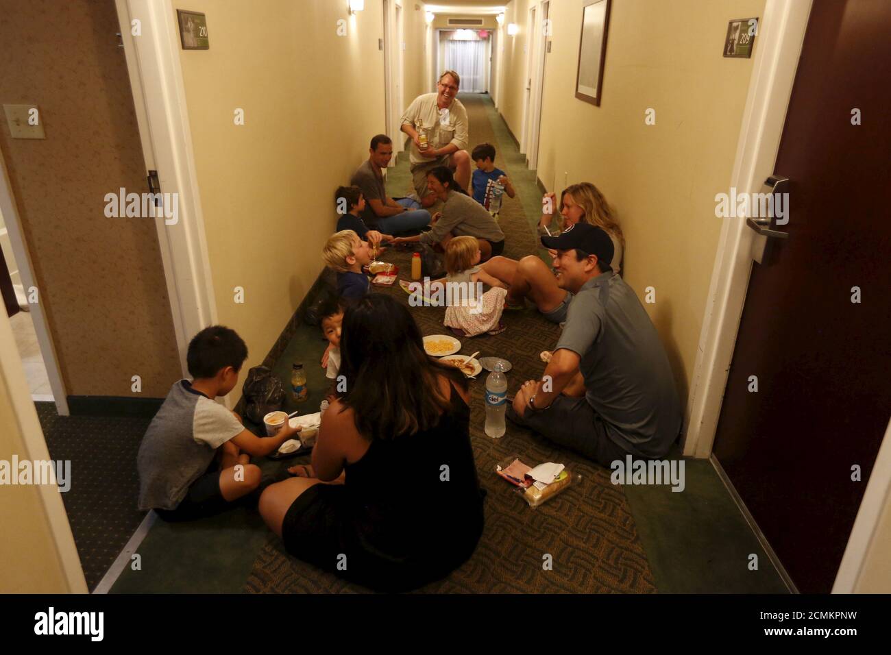 Tourists who arrived from Puerto Vallarta eat in a corridor of a hotel in Guadalajara, Mexico October 23, 2015. Hurricane Patricia, one of the most powerful storms on record, struck Mexico's Pacific coast on Friday with destructive winds that tore down trees, moved cars and forced thousands of people to flee homes and beachfront resorts. With winds of 160 miles per hour (266 km per hour), the Category 5 hurricane had western Mexico on high alert, with the popular resort of Puerto Vallarta and others on the coast opening emergency shelters as hotels were closed. REUTERS/Edgard Garrido Stock Photo