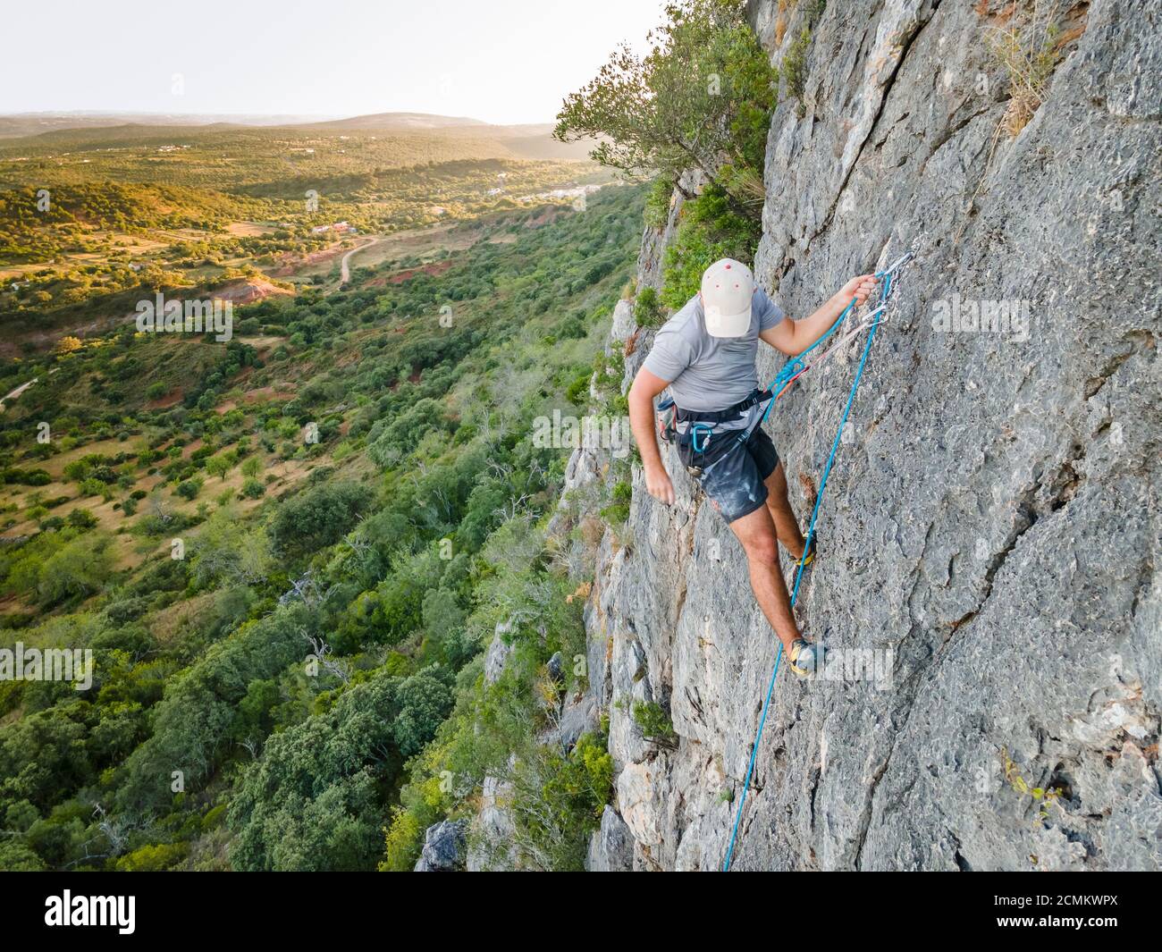 Man climbing a steep, plain rock in Portugal Stock Photo Alamy