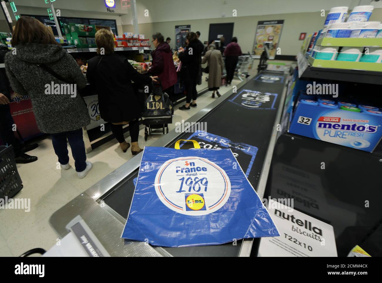 Customers wait cashes in a Lidl supermarket in Nice, France, March 2, 2020. REUTERS/Eric Gaillard Stock Photo - Alamy