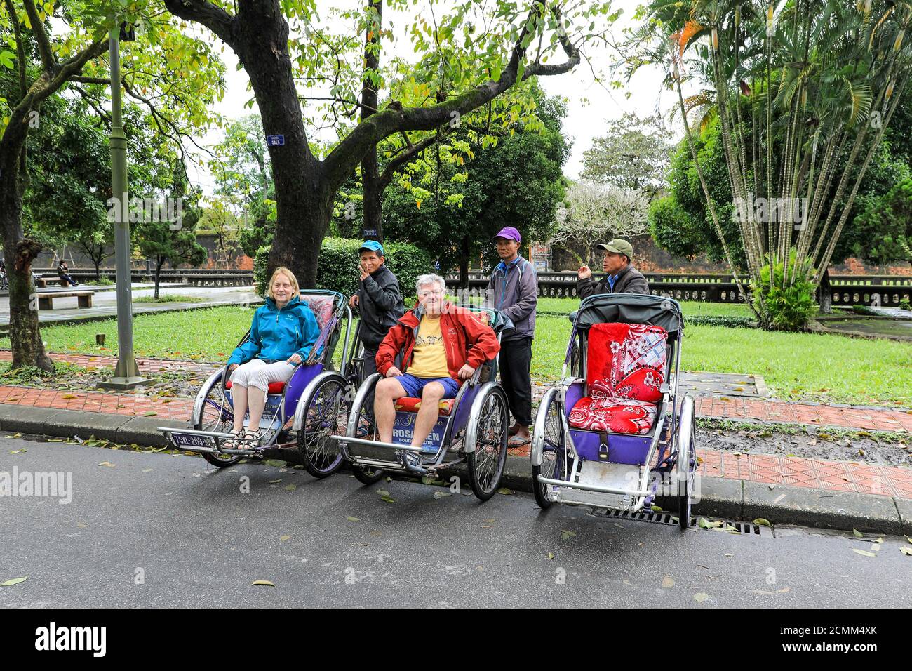 Tourists sitting in cyclo rickshaws, a three-wheel bicycle taxi, Huế, Vietnam, Southeast Asia, Asia Stock Photo