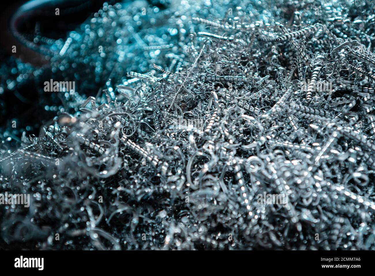 A pile of metal spirals as burr waste in metal processing. Stock Photo