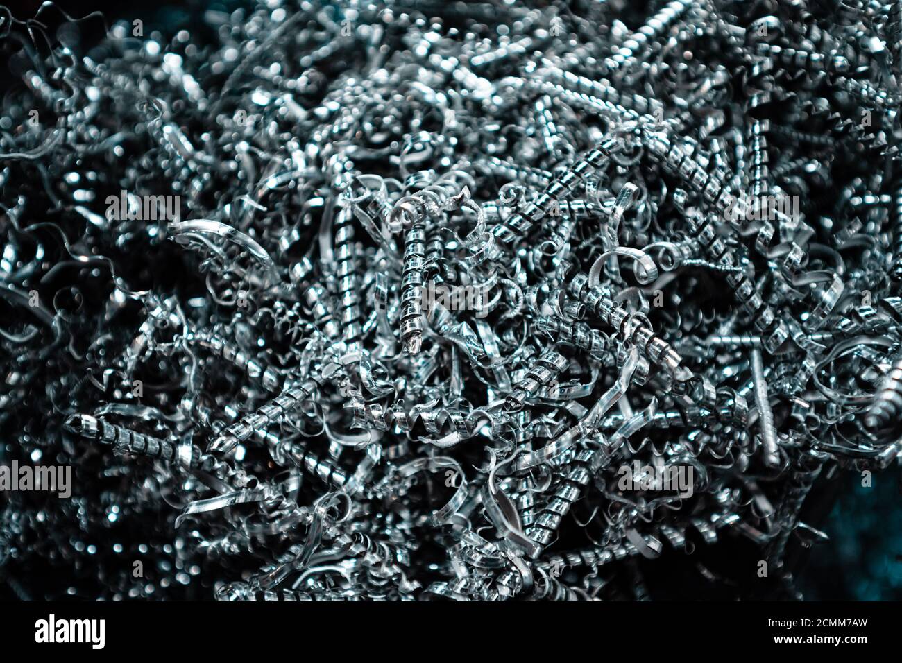 A pile of metal spirals as burr waste in metal processing. Stock Photo