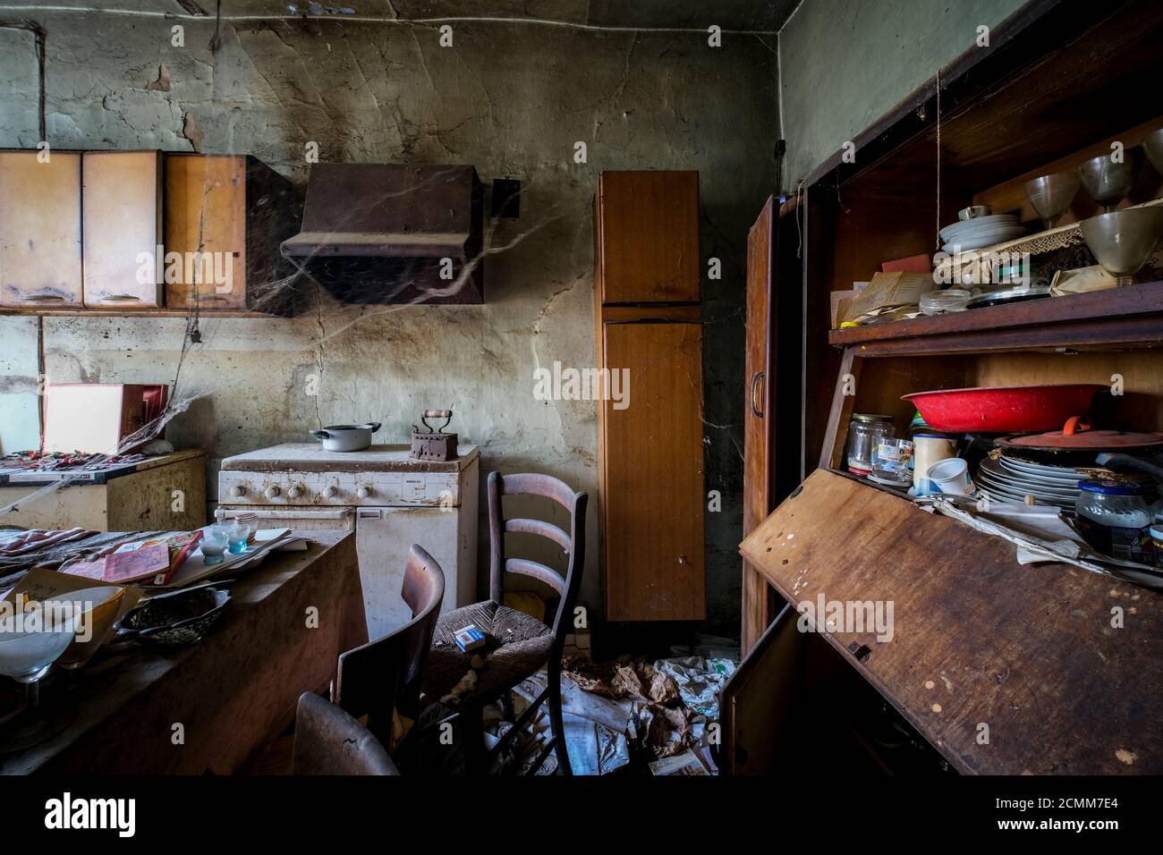 kitchen with table and dishes in abandoned old house with dust and cobwebs.  High quality photo Stock Photo - Alamy, image size:1300x956