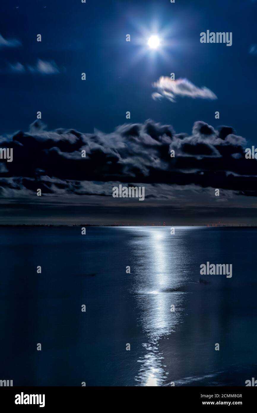Full moon reflecting on the water at the East Frisian island Juist, Germany. Stock Photo