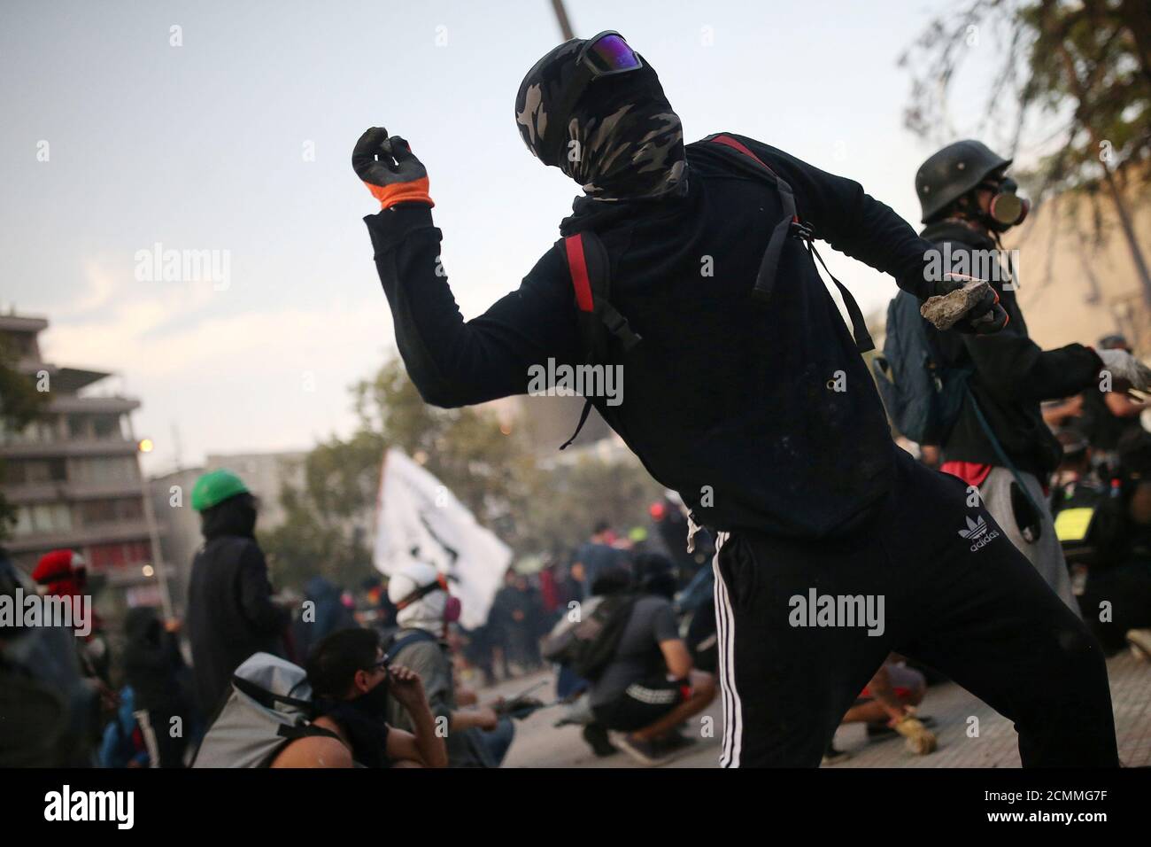 A demonstrator throws stones as he clashes with riot police during anti-government protests in Santiago, Chile January 24, 2020. REUTERS/Edgard Garrido Stock Photo